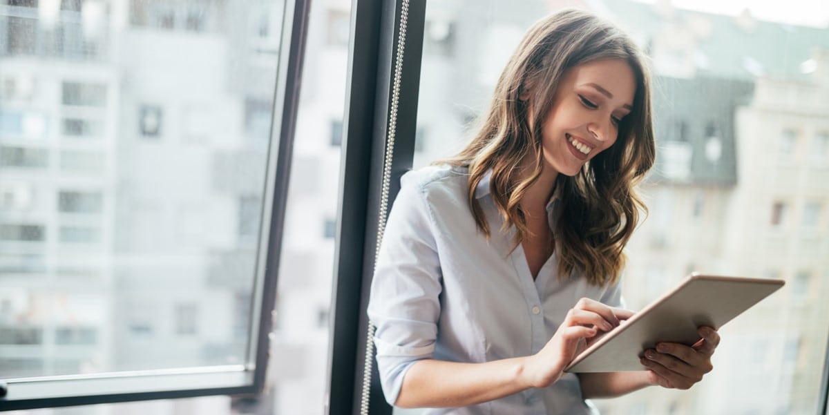 woman in office looking at tablet