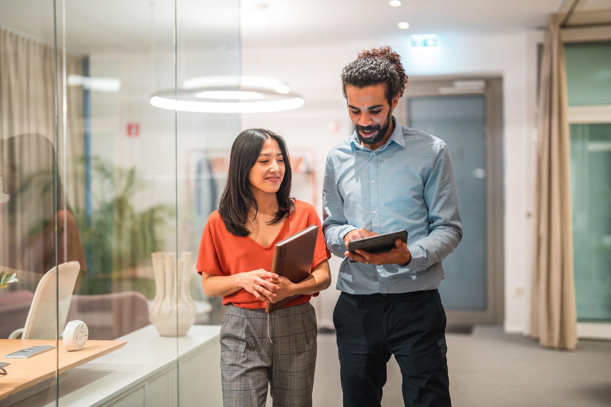 Two people looking at a tablet